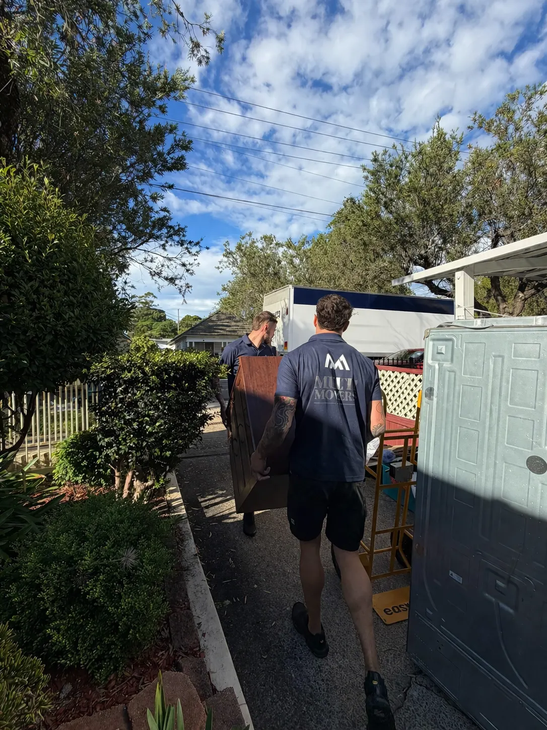 MultiMoversCo team carrying furniture on moving day