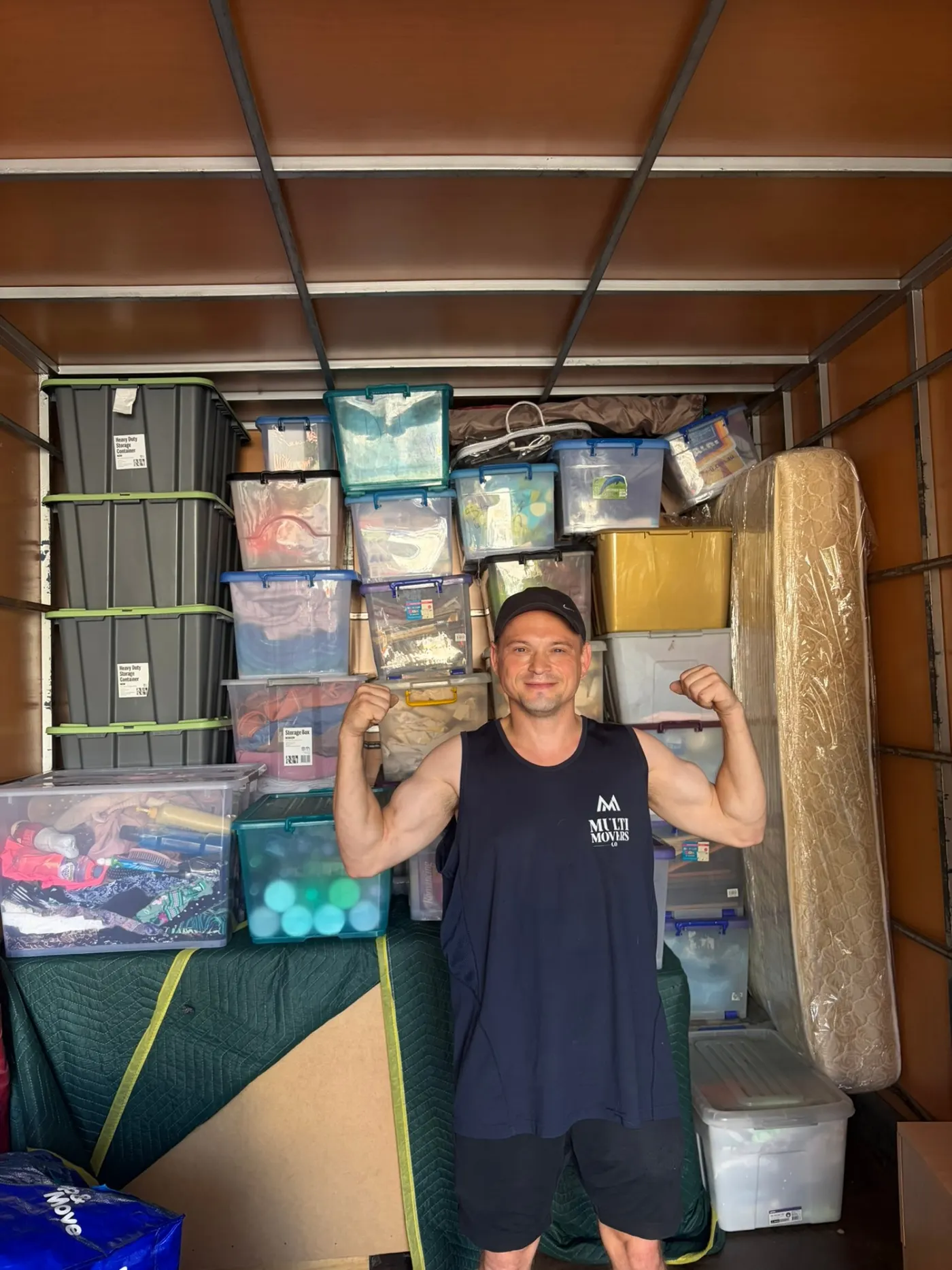 MultiMoversCo team member with fully packed moving truck